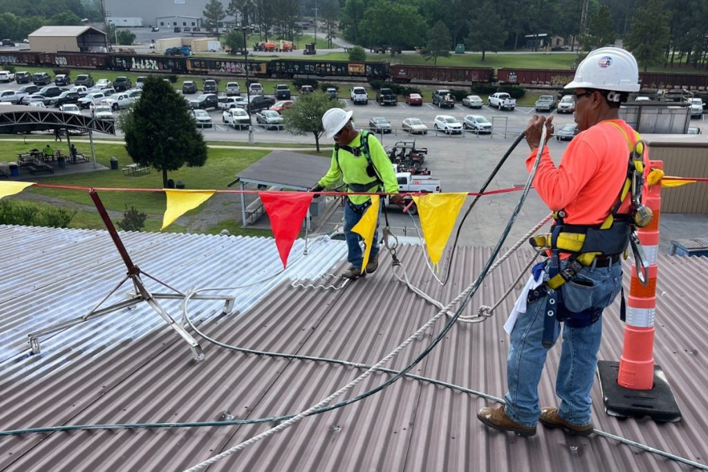 Ers Roofing Contractors on Commercial Roof Performing a Roof Coating